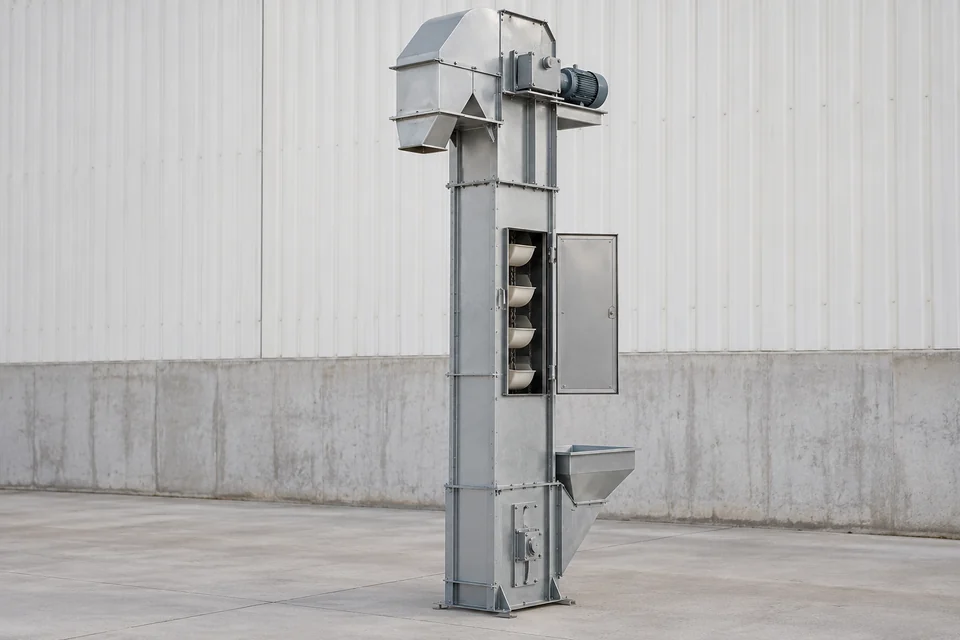 chain bucket elevator with vertical enclosed tower and visible bucket chain at an open maintenance panel