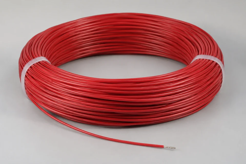 FEP insulated electrical wire coil with glossy fluoropolymer jacket